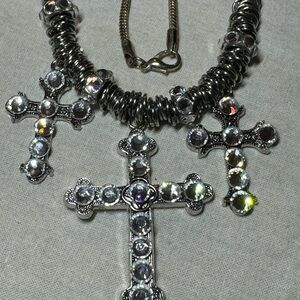 Pendant with 3 large crosses. Silver colored with sparkling clear stones